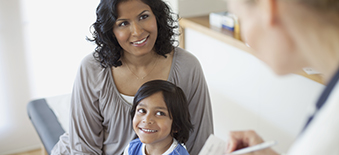 Mother and young daughter speak with clinician