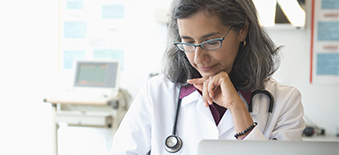 Female doctor working on laptop