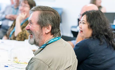 People around a table smiling and laughing