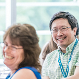 Woman laughing and man smiling.