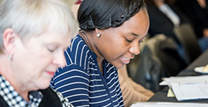 Two patients reading materials in a patient engagement meeting