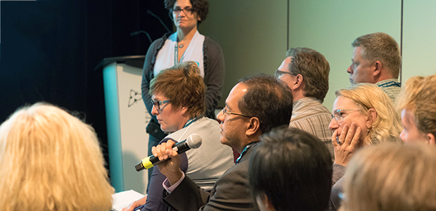 Man at a breakout session speaking on a microphone