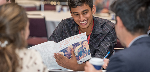 Attendee reviewing conference program 