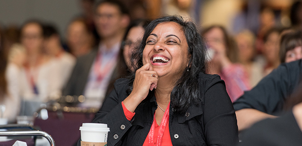 Women smiling at a conference