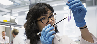 Technician in a lab looking at evidence