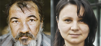 An elderly, bearded man and a young woman with brown hair looking at the camera