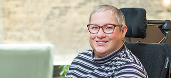 Woman sitting in a wheelchair and smiling