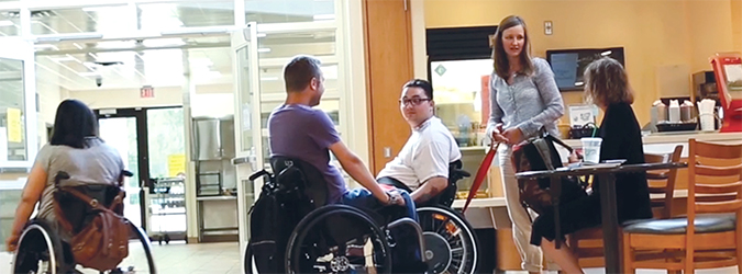 Female physiotherapist assisting two male patients