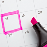 Picture of a calendar with one day highlighted in pink
