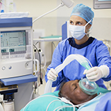 Clinician administers anesthesia to surgical patient 