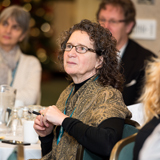 Men and women listening to a speaker at a quality improvement event