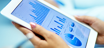 An iPad displaying graphs and data tables