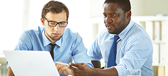 Two administrators reviewing reports