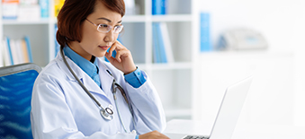 A female doctor looking for information on her laptop computer