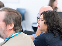 Woman listening to a group discussion