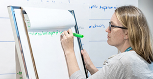 Woman taking notes during a discussion