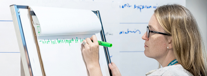 Woman taking notes during a discussion