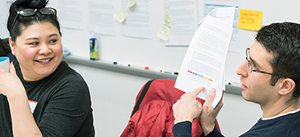 male pointing to paper and discussing