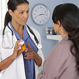 A doctor speaking to a patient in a doctor's office