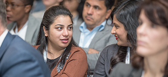 Two women talking at a conference