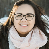 Young woman who shared her experience about health care in Northern Ontario standing outside her home in Moose Factory on a cold sunny winter day