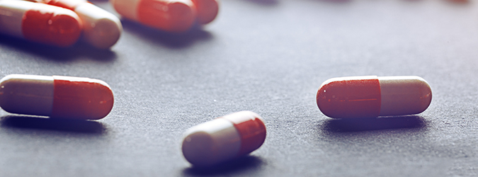 Photo of red and white pill capsules on a table